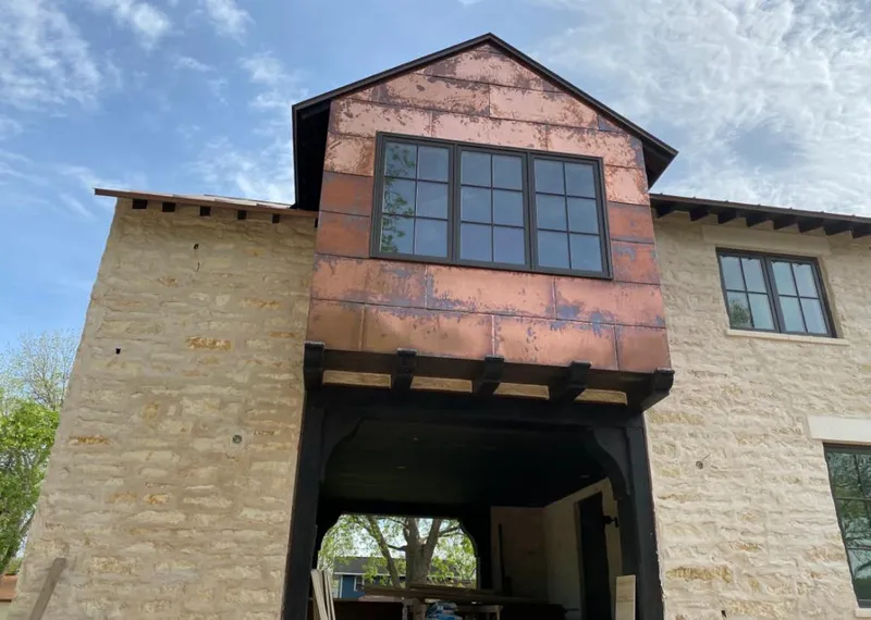 Copper metal panel facade on a stone building for Roof Repair in Oak Ridge